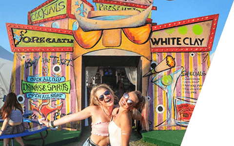 Festivalgoers posing at a colorful branded cocktails activation booth