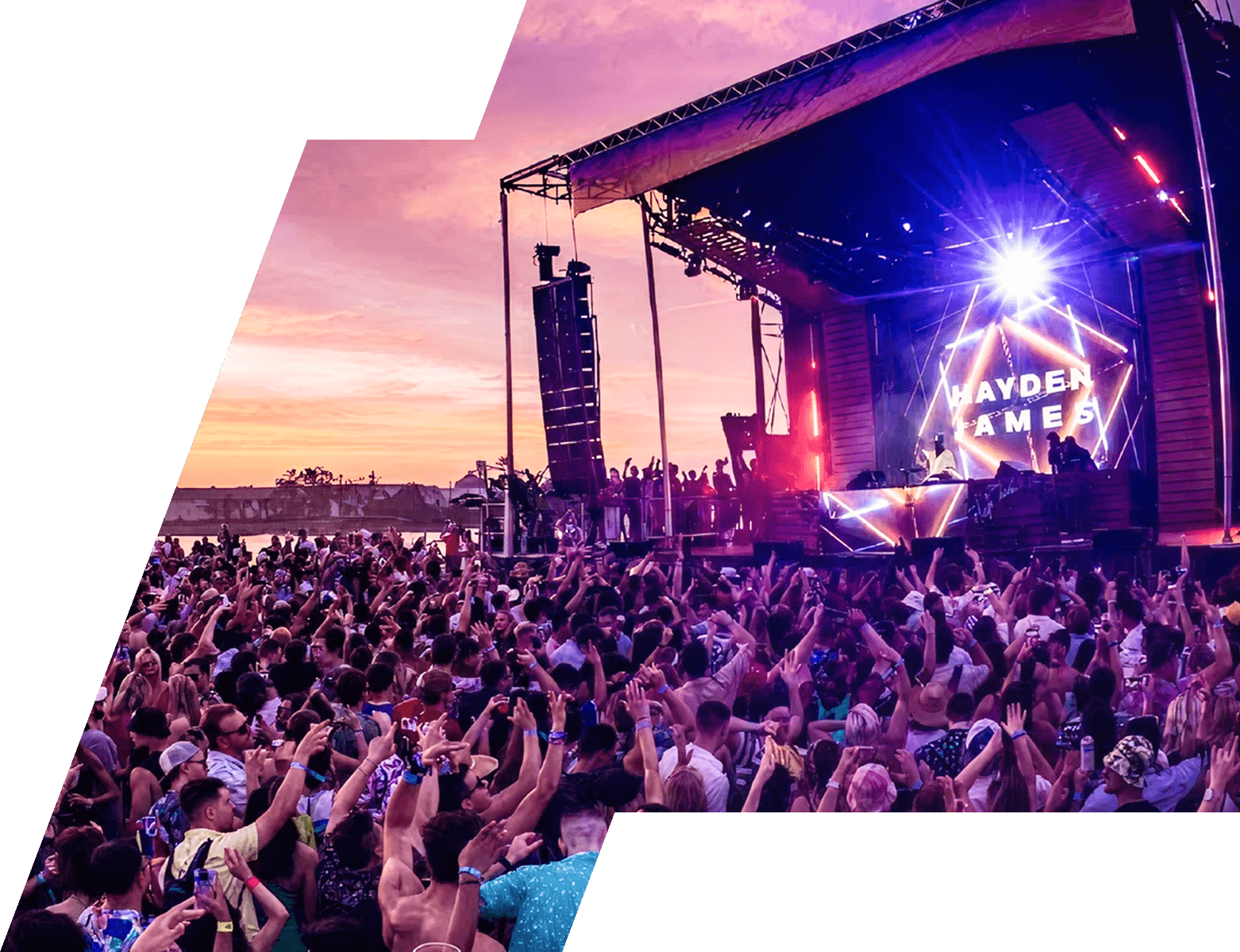 Festival guitarist performing to a large sunset crowd — feasibility study reference