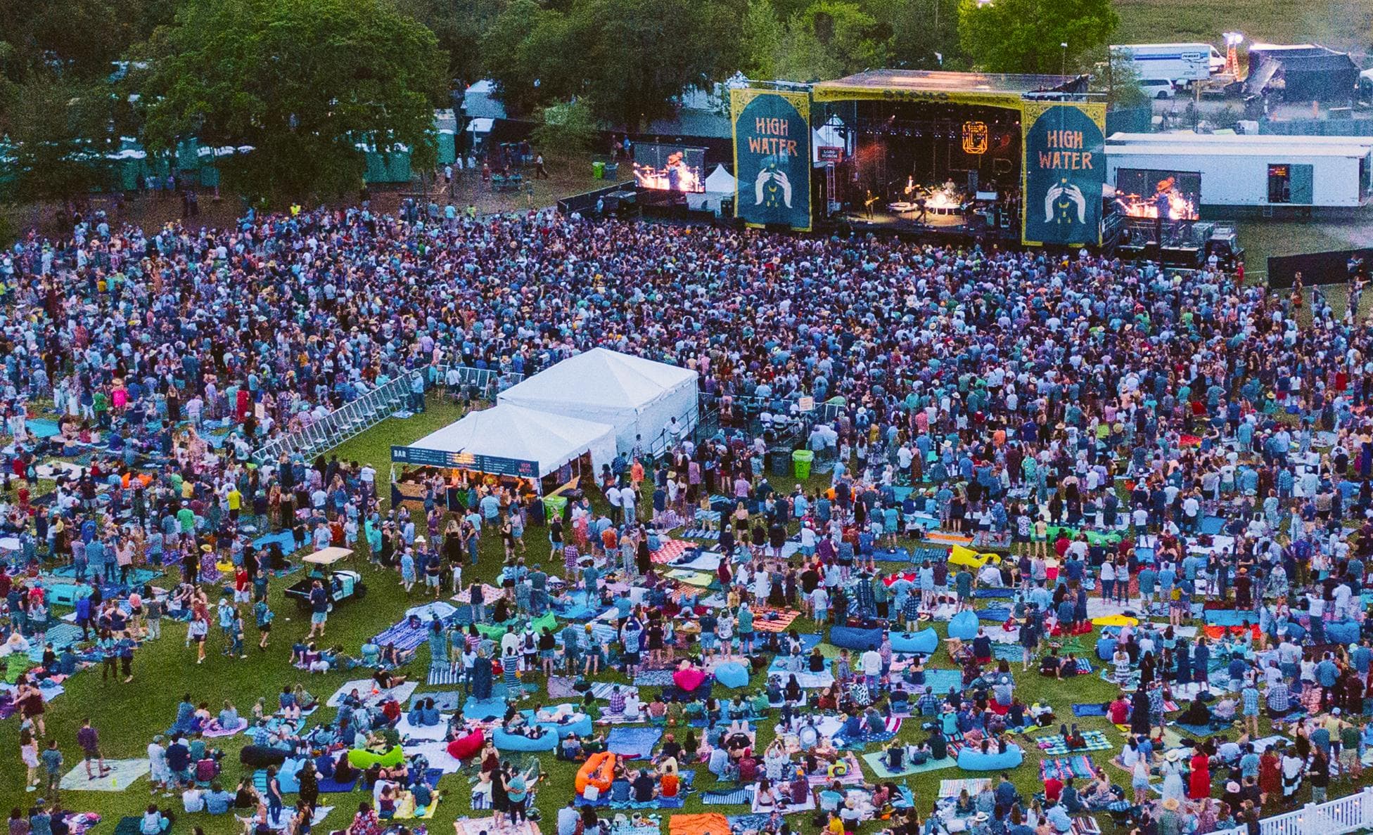 Aerial dusk view of a huge crowd facing the High Water festival main stage