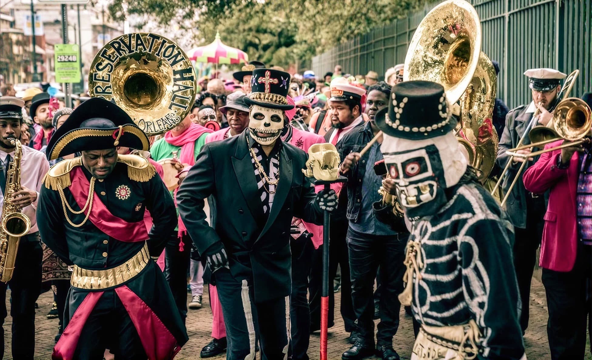 New Orleans brass band second line parade in skeleton and Baron Samedi costumes with a Preservation Hall sousaphone