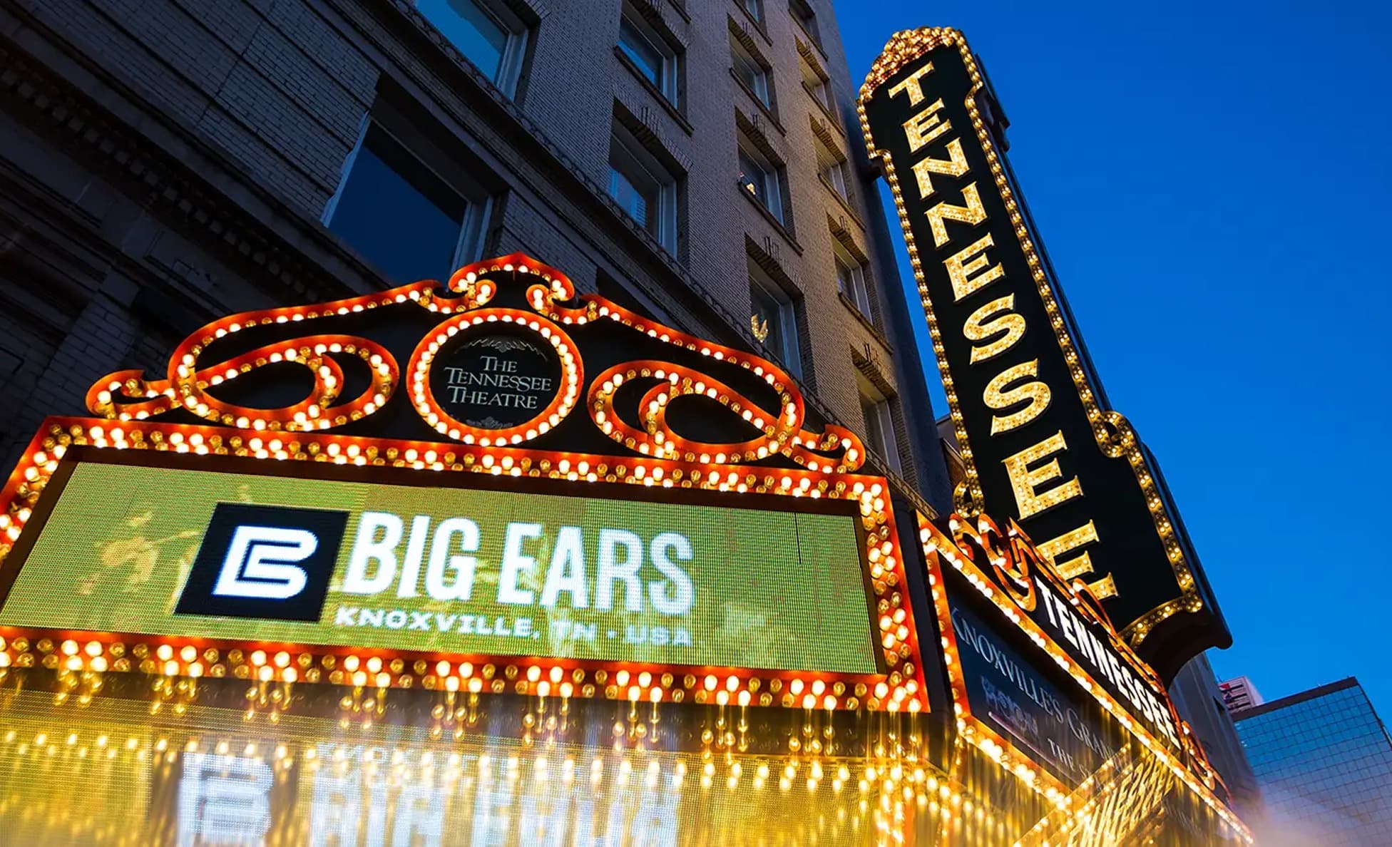 The Tennessee Theatre marquee lit up at dusk displaying Big Ears in Knoxville