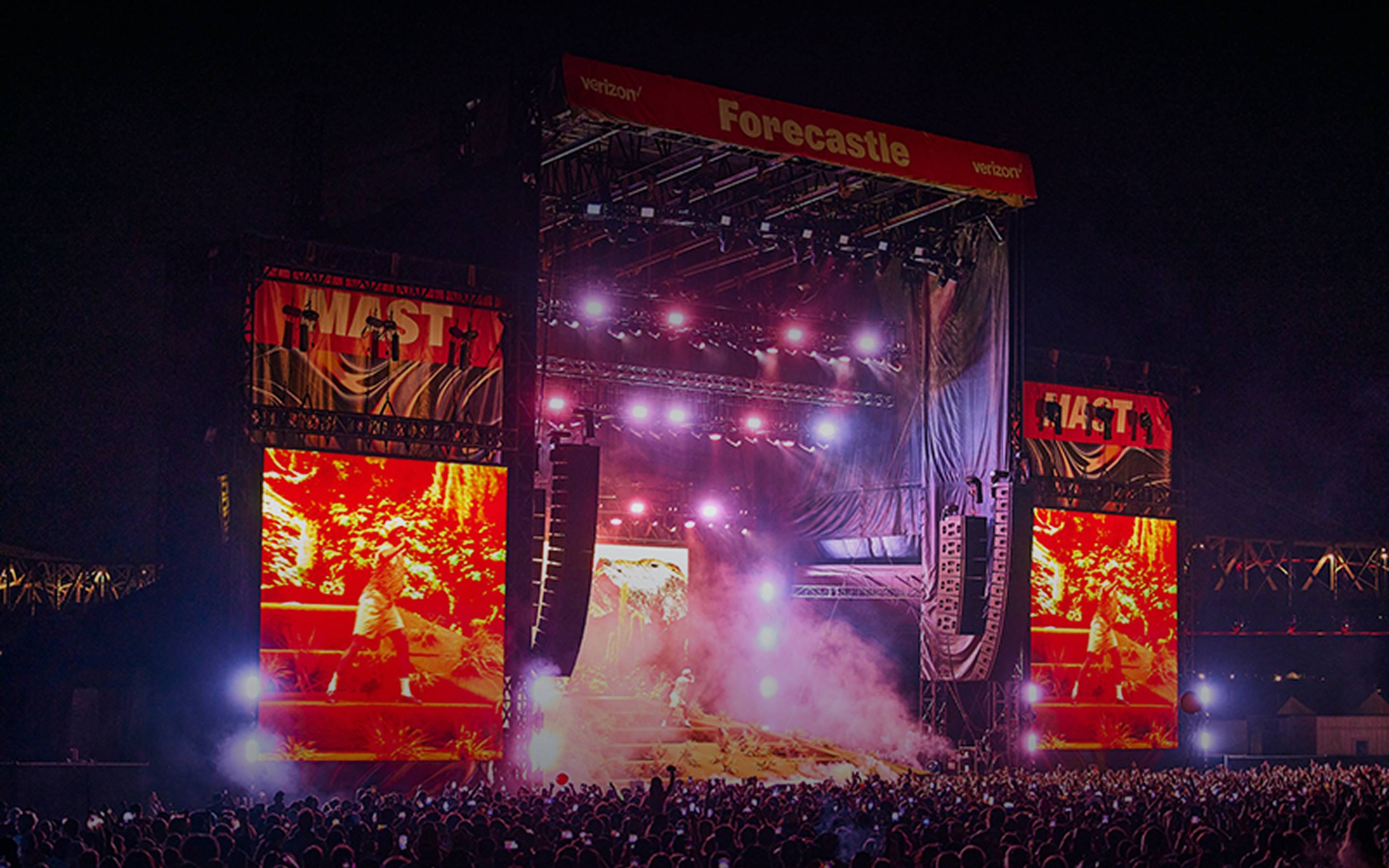 Forecastle festival main stage at night with a packed crowd, dramatic stage lighting, and large LED screens