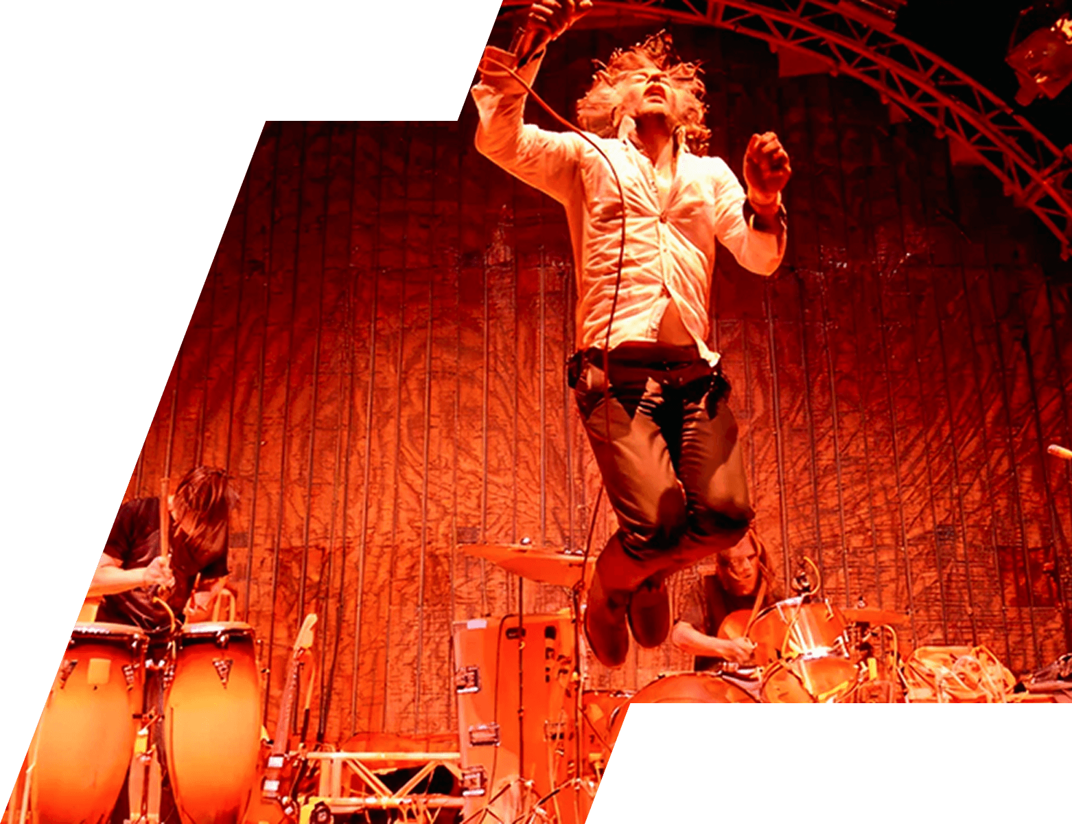 Festival performer commanding the stage under dramatic red lighting