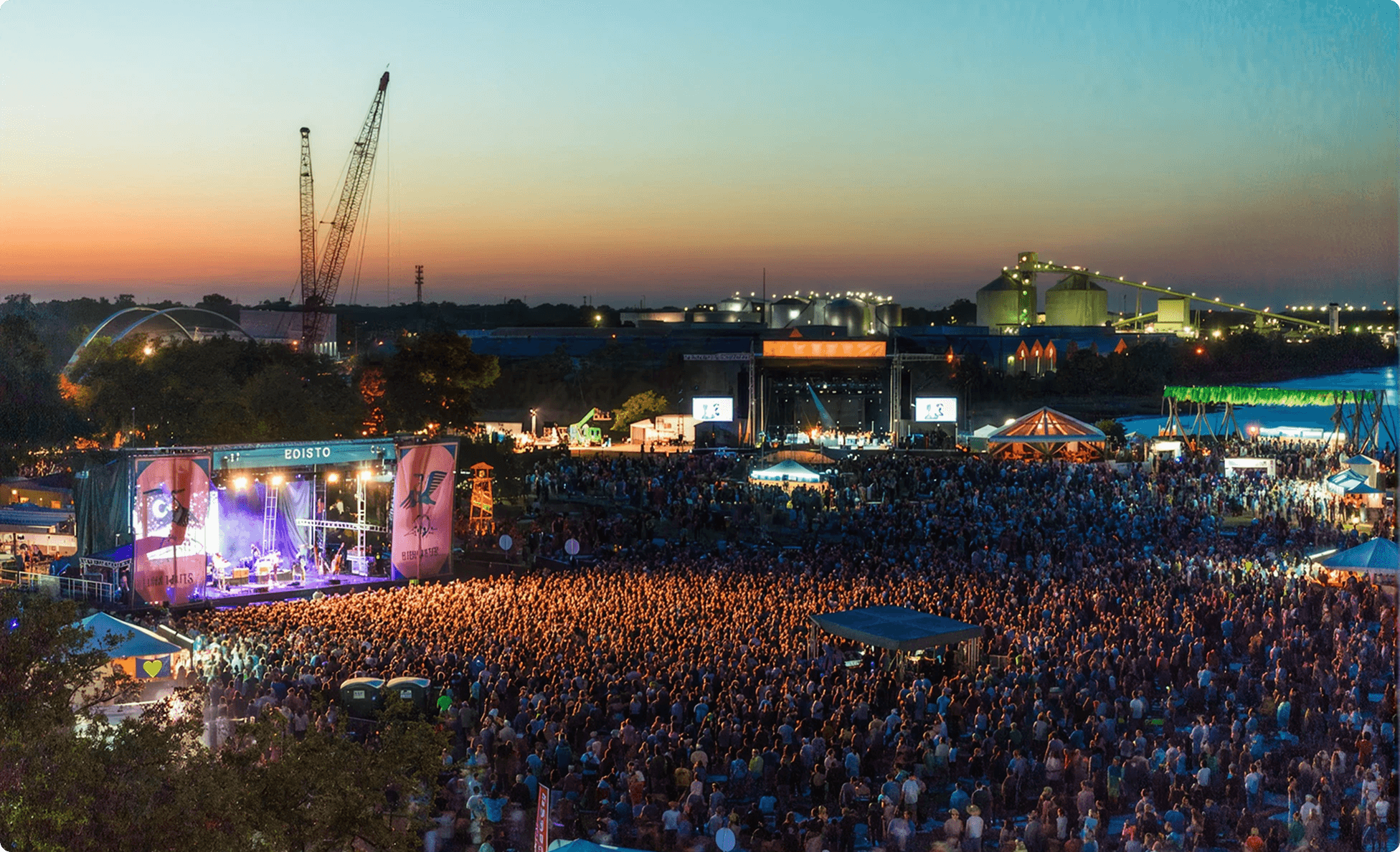 Large festival crowd at dusk facing the Edisto stage