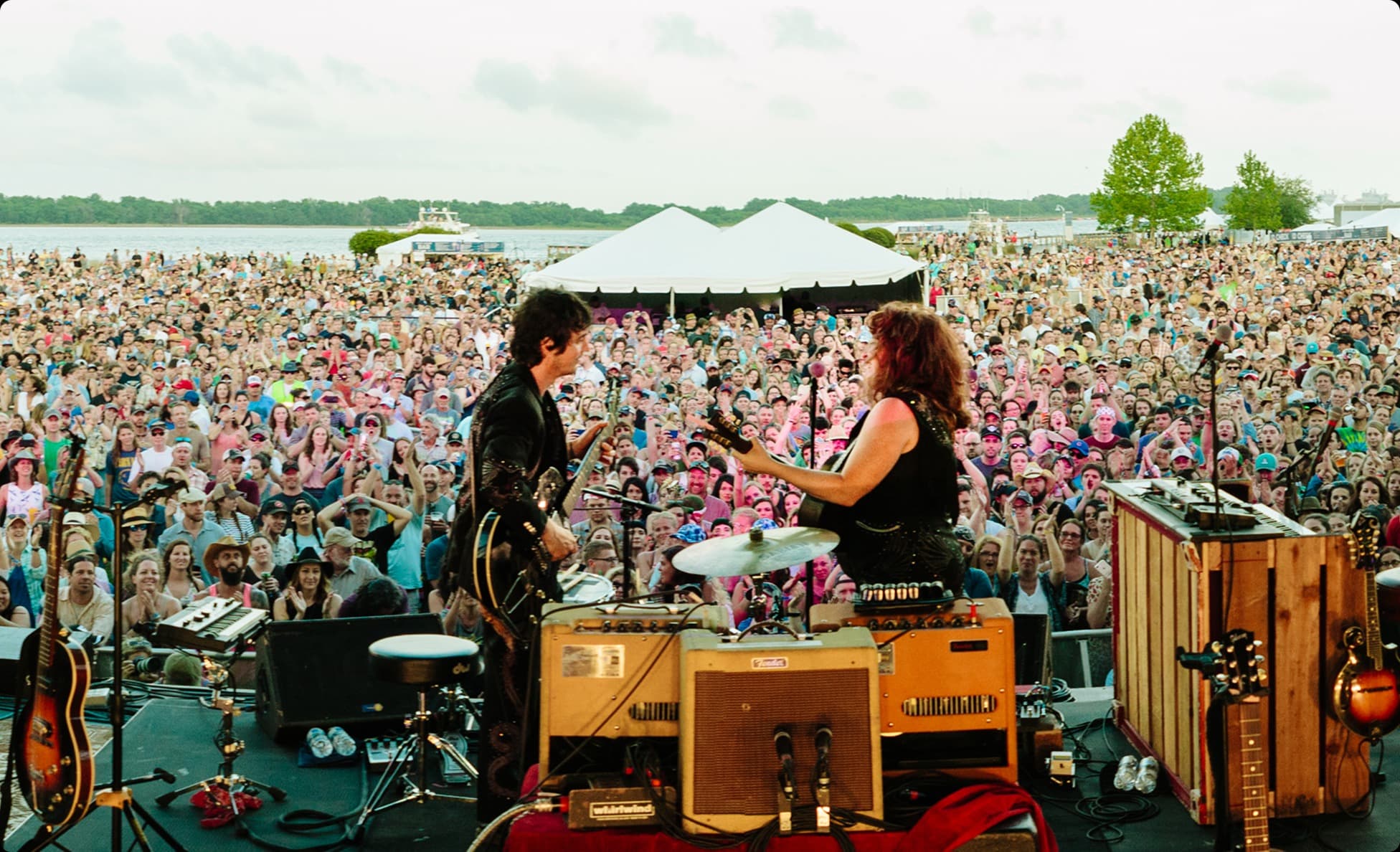 View from the stage of a duo performing to a large lakeside crowd