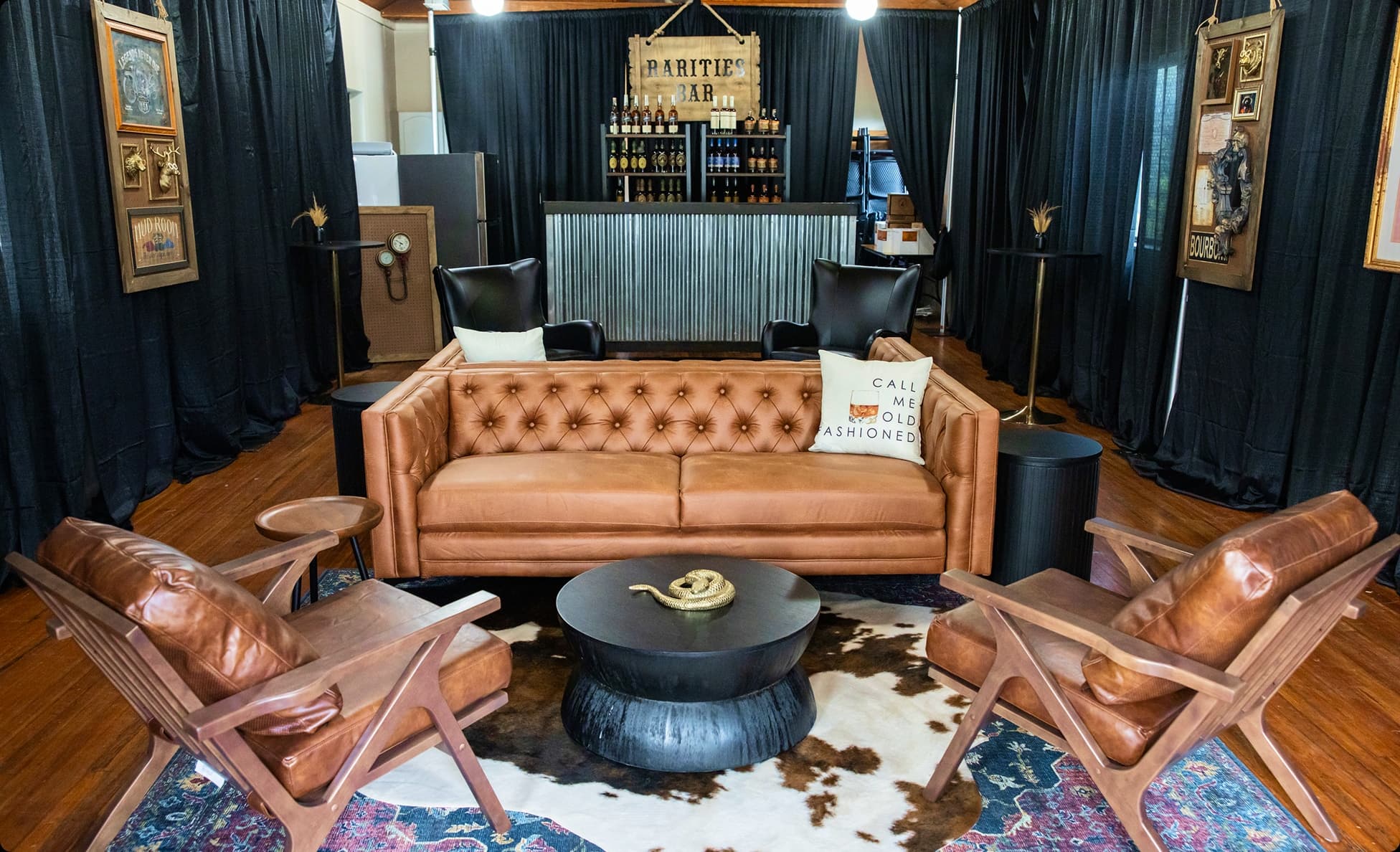 VIP lounge styled with leather sofas, cowhide rug and a whiskey bar