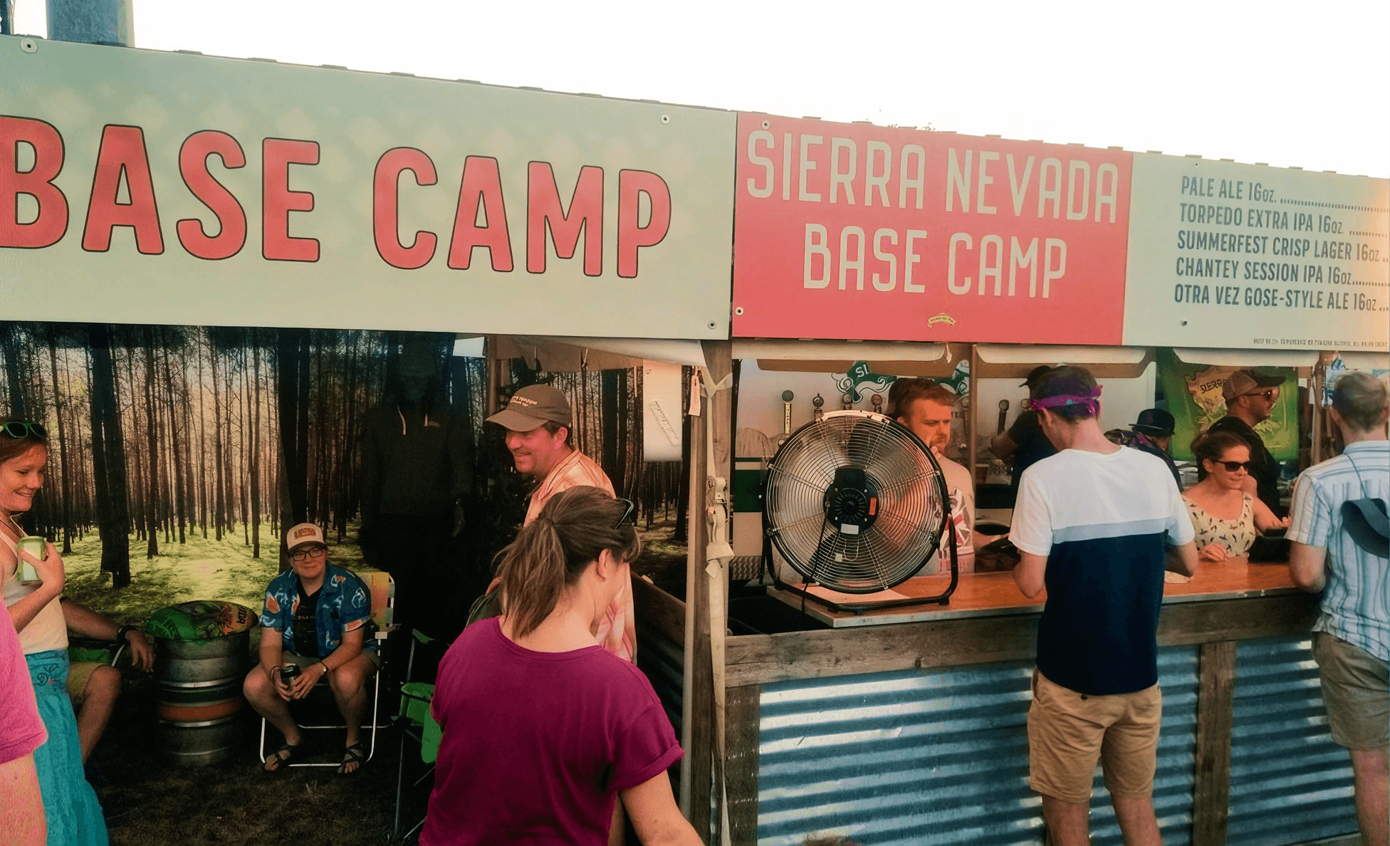 Sierra Nevada Base Camp branded beer bar with a draft menu and festival-goers being served
