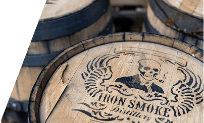 Iron Smoke whiskey sponsor activation booth featuring a custom barrel display